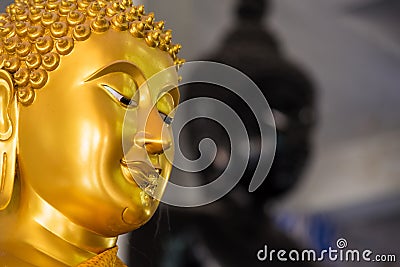 Close up gold Buddha face statue Stock Photo