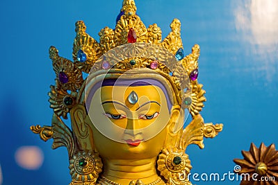 Close up of Gold covered statue of buddhist deity of compassion Chenrezig. Stock Photo