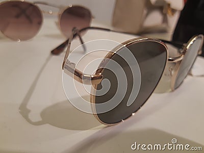 A close-up of gold-framed round sunglasses Stock Photo