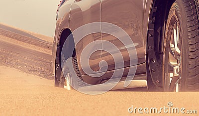 Close up of a golden car stuck in the sand in the Namib desert Stock Photo