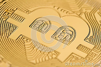 Close up of on a golden coin bitcoin logo Stock Photo