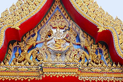 Close up of golden red carving. The temple beautifully adorns wooden carvings depicting Buddha`s life familiarized by Jataka Tale Stock Photo