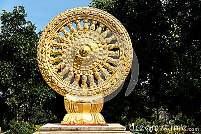 Close up Golden Wheel of Dhamma or Wheel of life and symbol teaching of the Lord Buddha, Symbol of Buddhism in the temple, Stock Photo