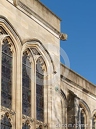 Close-up of Gothic style stained glass windows and Gargoyle. Stock Photo