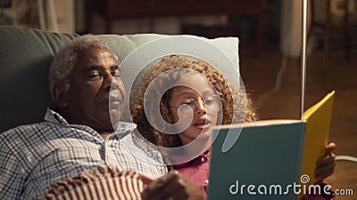 Close-up of granddaddy and granddaughter resting together Stock Photo