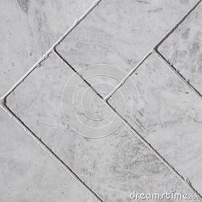 Gray floor tiles, herringbone pattern, close-up Stock Photo