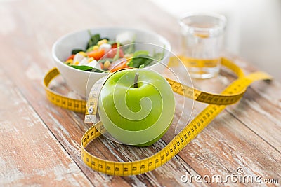 Close up of green apple and measuring tape Stock Photo