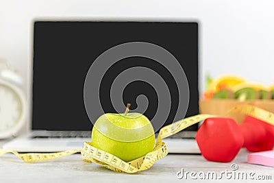 Close up green apple and tape measure. Healthy snack for diet planning for working in office. Stock Photo