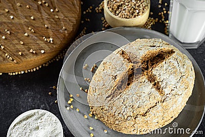 Close up green buckwheat bread and organic buckwheat milk. gray homemade Ceramic plate, linen napkin. Harmless, wellness, gluten Stock Photo