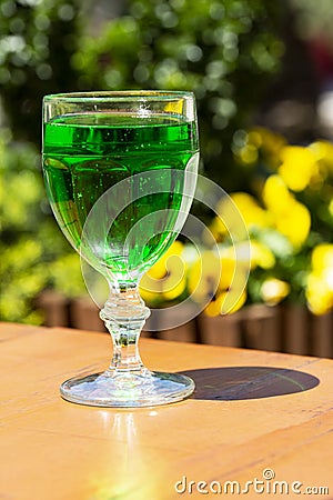 close-up Green lemonade Tarragon in a glass glass on a blurry background. Green drink from healthy herbs Tarragon Stock Photo