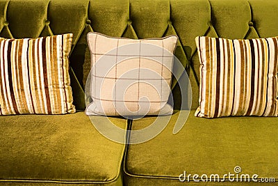 Close up of green velvet sofa and cushions Stock Photo