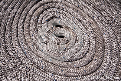 Close up of grey nautical rope coiled and with blue highlights Stock Photo