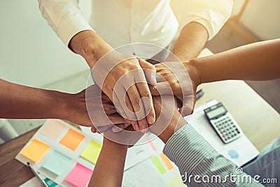 Close up of group of business people joining their hands together in unity Stock Photo