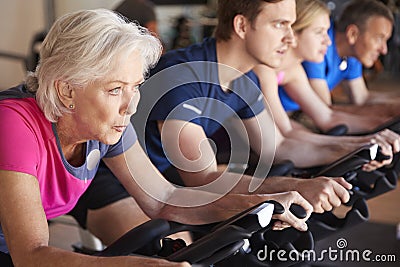 Close Up Of Group Taking Spin Class In Gym Stock Photo