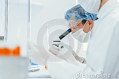 Close up. group of virologists in protective clothing works in the laboratory. Stock Photo