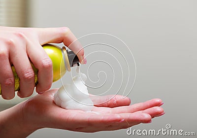 Close-up hairdresser hand hair mousse spray. In hairdressing beauty salon Stock Photo