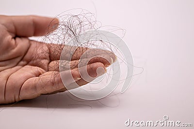 Close up hairs loss fall with in holding hand isolate on white background. Stock Photo