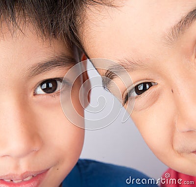 Close up on half eyes of sibling brother smiling together Stock Photo