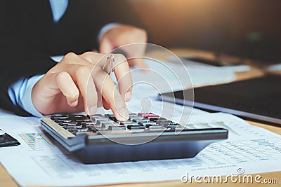 close up hand accountant using calculator with laptop. concept s Stock Photo