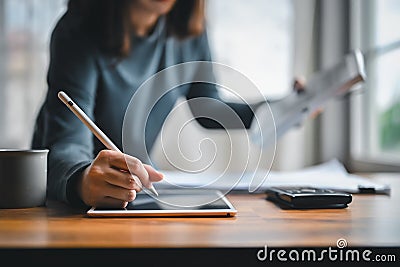 Close-up hand of Alternative energy engineers using technology tablet for learning design and calculation for energy accumulation Stock Photo