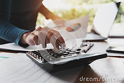 close up hand of business woman using calculator for working Stock Photo