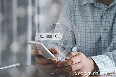 Close up Hand businessman holding silver mobile phone on office deck workplace. checking email message, Searching webpage internet Stock Photo