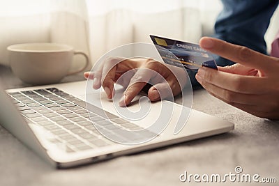 Close up hand of businessmen are buying online with a credit card. Men are using laptop and doing online transactions Stock Photo