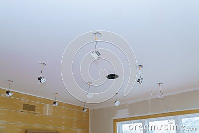 Close-up hand changes a light LED in a stylish preparations for ceiling lamp interior lighting installation Stock Photo