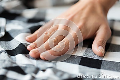 Close up of hand with checkered clothing item Stock Photo