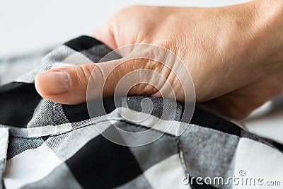 Close up of hand with checkered clothing item Stock Photo