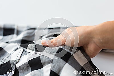 Close up of hand with checkered clothing item Stock Photo