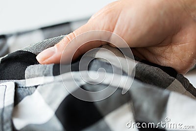 Close up of hand with checkered clothing item Stock Photo