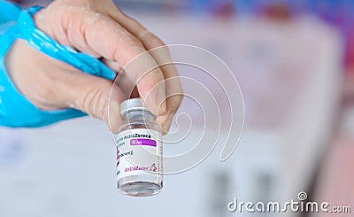 Close-up hand doctor who showing vaccine AstraZeneca vial form Siam Bioscience for injection to people Editorial Stock Photo
