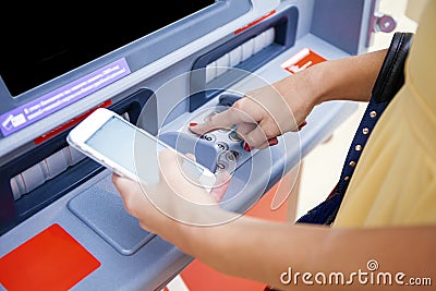 Close up of hand entering pin at an ATM. Finger about to press a Stock Photo