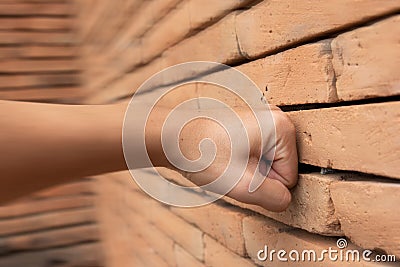 Close up Hand Fist smash the brick wall Stock Photo