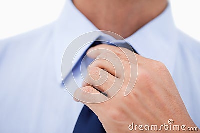 Close up of a hand fixing a tie Stock Photo