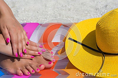 Close-up hand and foot on a pink air mattress in swimming pool. Stock Photo