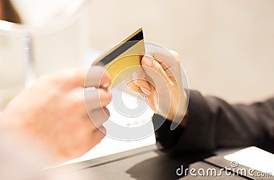 Close up of hand giving credit card to seller Stock Photo