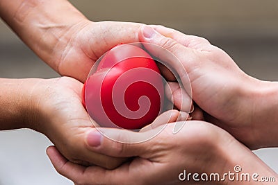 Close up hand giving red heart as heart donor. Valentine day of love concept. Medical ventilator and heart donator charity. Sign Stock Photo