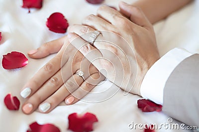 Close up hand groom couple lovers show wear the Wedding Ring on bride Holding hands together Stock Photo