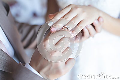 Close up hand groom couple put giving the Wedding Ring on bride. Stock Photo