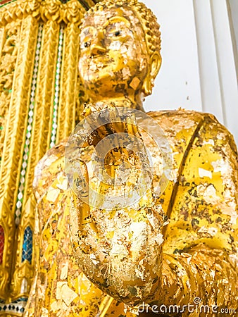 Close up hand and head filled with gold leaf of statue Buddha. concept shows the devotion of the Buddhists Stock Photo