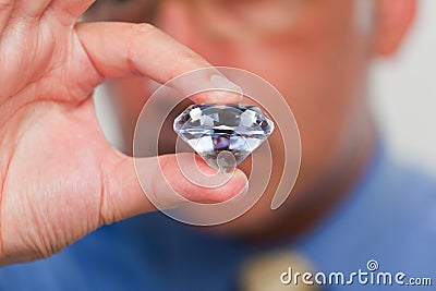 Close up of a hand holding a fake diamond Stock Photo