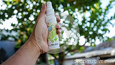 Close up of hand holding hand sanitizer spray Editorial Stock Photo