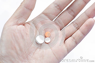 Close up hand holding pill Stock Photo