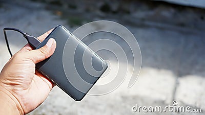 Close up hand holding portable hard drive Stock Photo