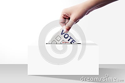 Close up of hand holding voting paper for election vote into box Stock Photo