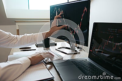 Close up of hand investors are pointing to laptop computer that have investment information stock markets and partners taking Stock Photo