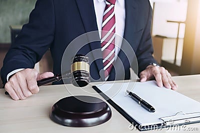 Close up of hand, Judge hitting gavel and scales of justice, Rep Stock Photo