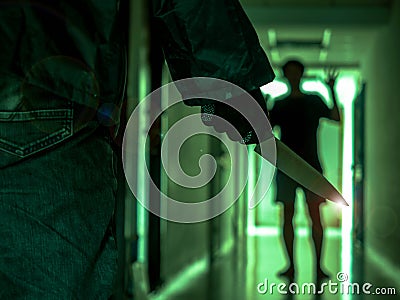 Close up of Hand with knife following young terrified in the apartment. man Bandit is holding a knife in hand, Threat Concept, Stock Photo